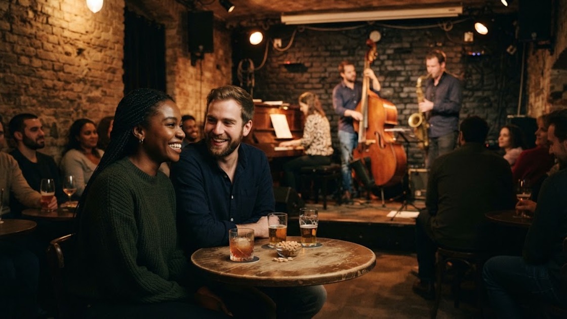 Jazz clubs in Berlin: two friends laughing at a small table while a trio plays in a brick-walled basement club