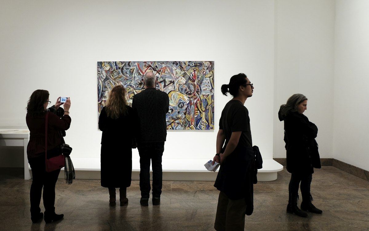 Friends looking at a painting in a gallery